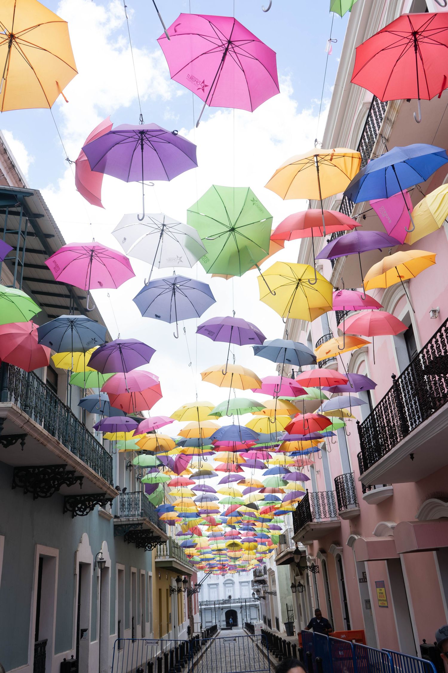 Colorful floating umbrellas installation over a narrow street in Old San Juan, Puerto Rico.