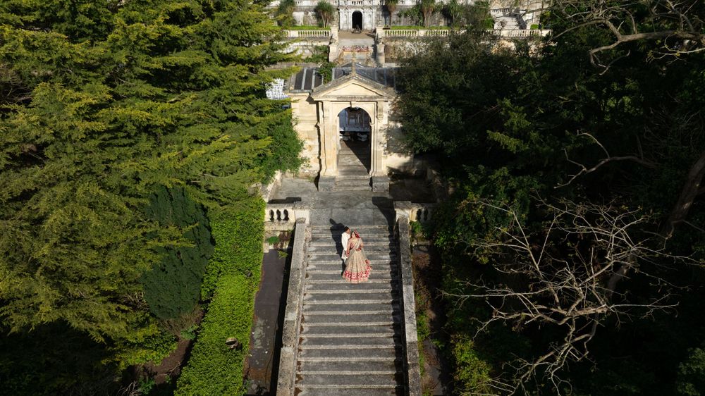 A grand stone staircase leads to an ornate archway at a majestic estate venue. Shrubland Palace Asian Wedding Photography