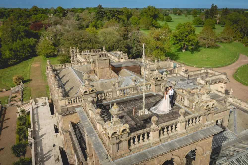 Aerial view of a wedding ceremony at an ornate historic mansion with manicured grounds. Shrubland Palace Asian Wedding Photography