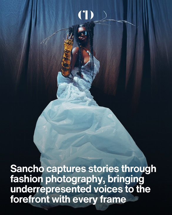 Artistic fashion photo of a model in flowing white gown against dark backdrop.
