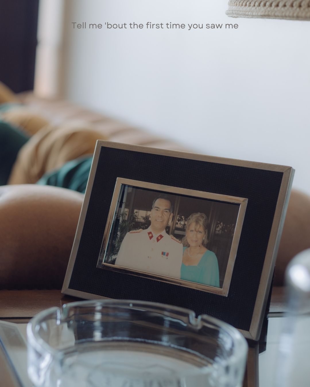 Framed black-and-white photo of a couple on a glass table with sentimental text overlay.