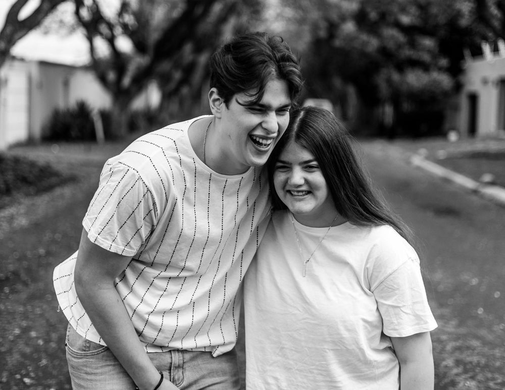 Romantic black and white photoshoot showing tender moments between a couple outdoors.