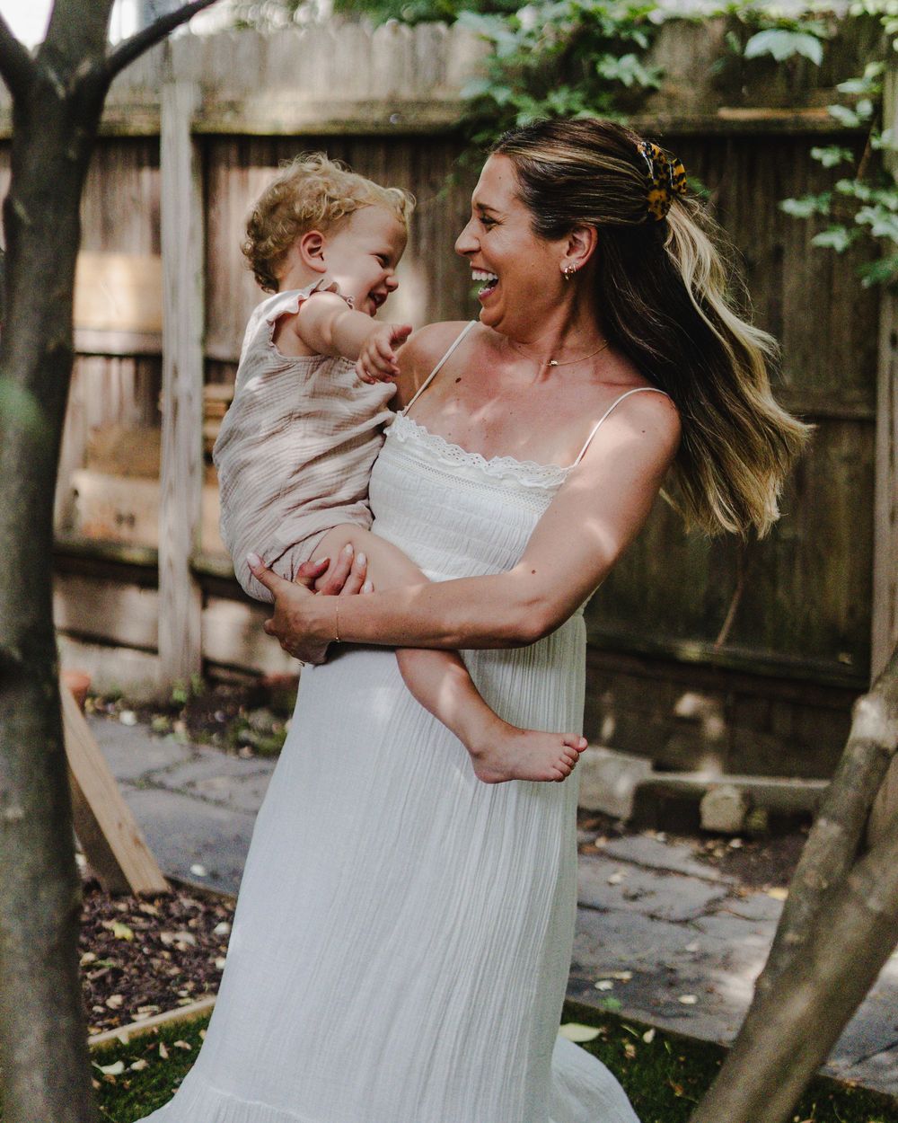 Candid moments of joy captured in backyard garden setting.