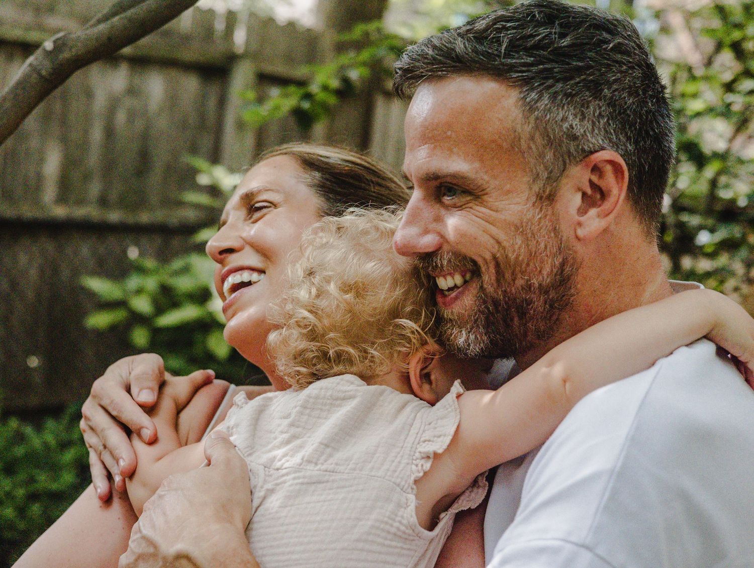 Joyful outdoor interactions with a young child in a natural setting.