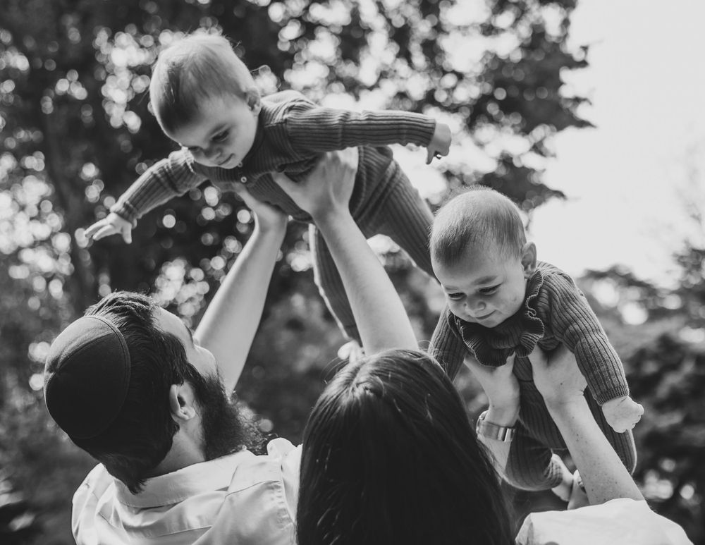 Black and white photograph of people dancing together outdoors.