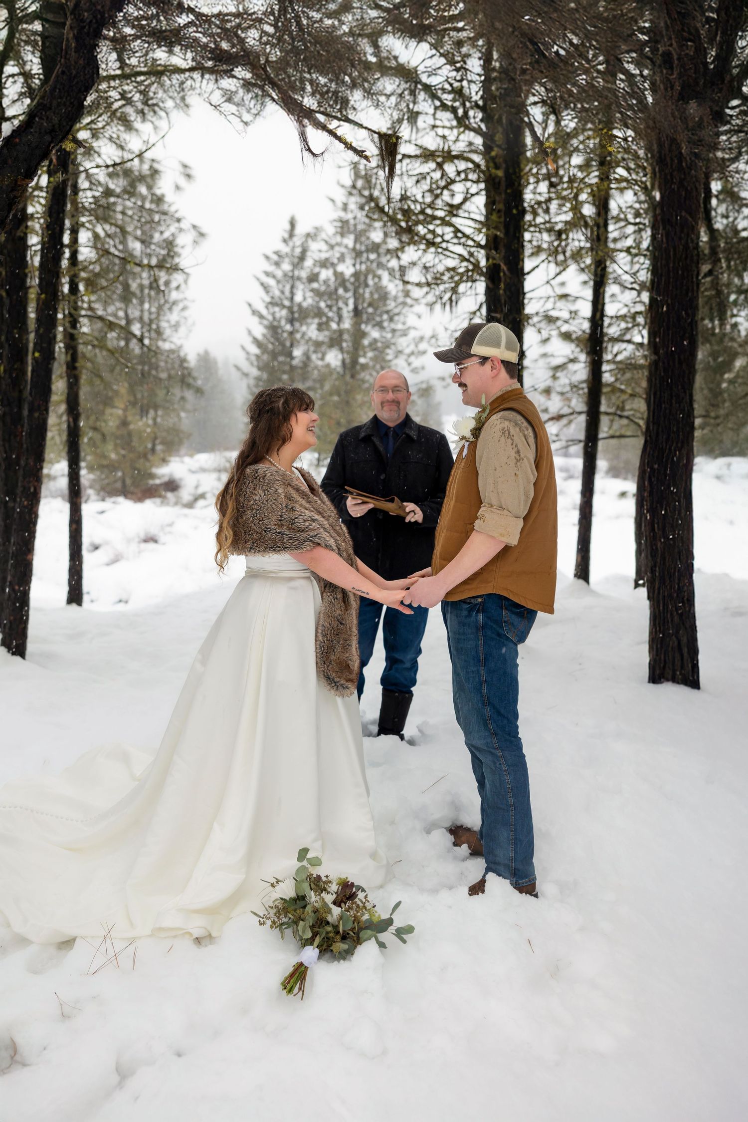 snowy elopement with officiant during ceremony Boise Elopement ©Milestones Studios LLC