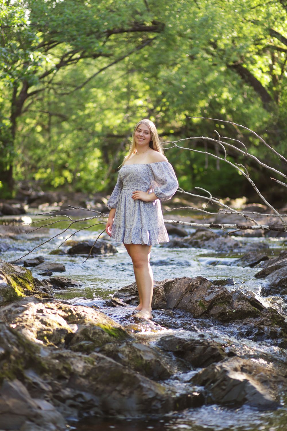 High school senior photographed near Lake Superior water and rocks