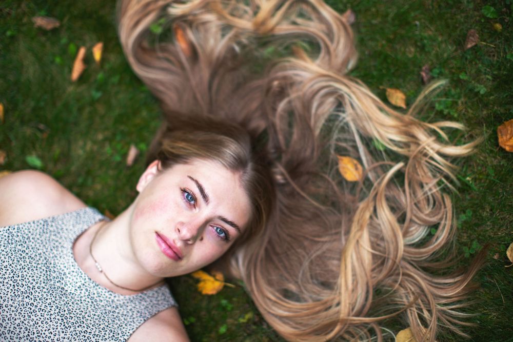 Confident high school senior photographed outdoors near Lake Superior