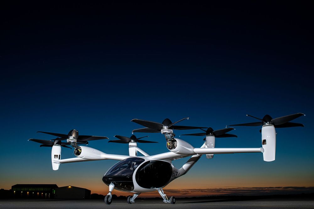 Row of small aircraft silhouetted against a dramatic sunset sky.