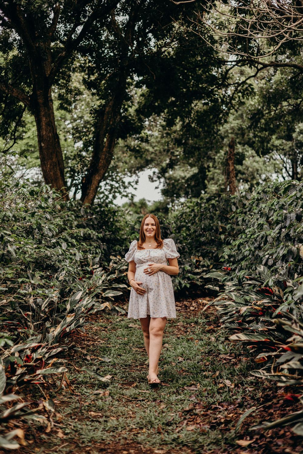 A dreamy outdoor photoshoot in a wooded area with natural lighting filtering through trees.