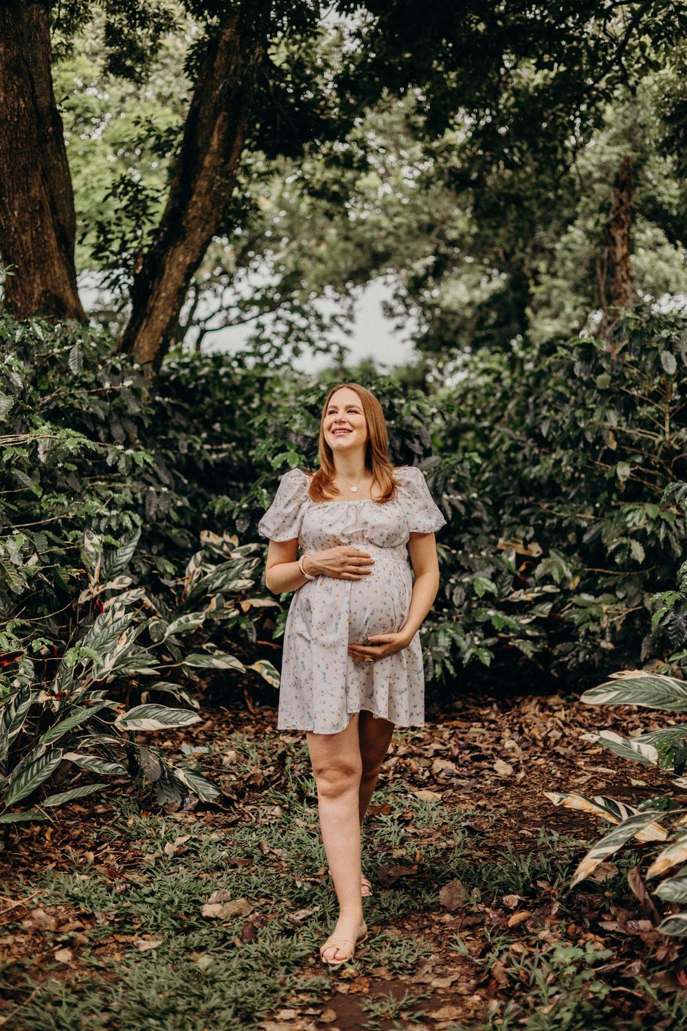 Playful outdoor photoshoot in a natural forest setting with dappled sunlight.