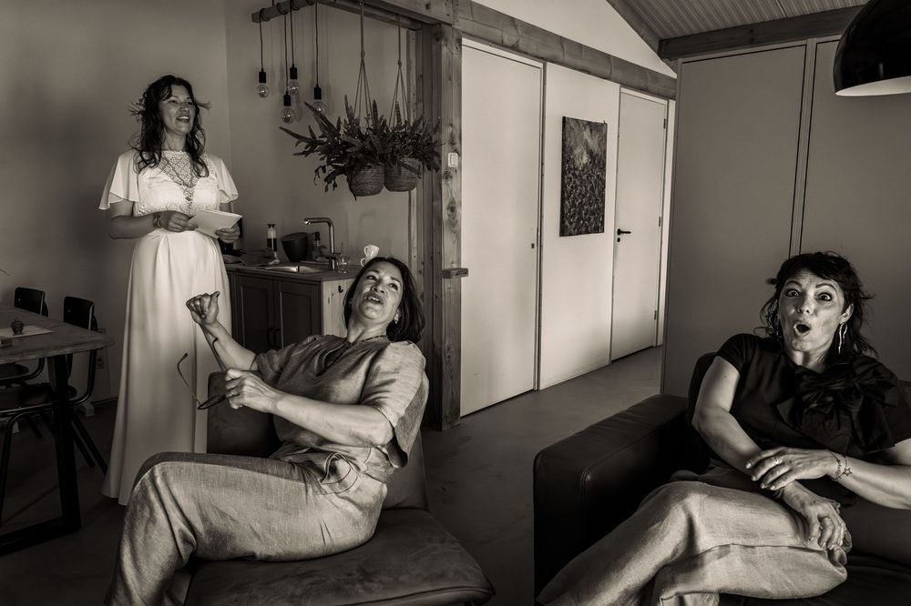 A series of intimate black and white portraits showing relaxed poses in an indoor setting.