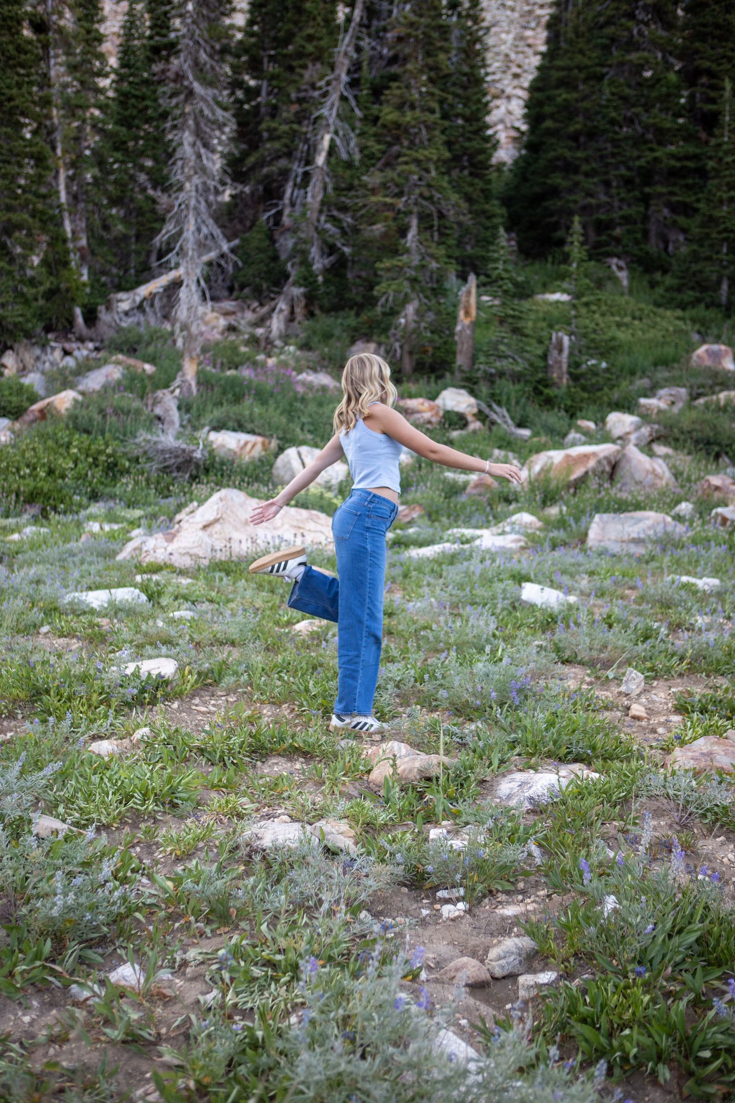 Senior pictures in the mountains of Idaho, walking through the fields of wildflowers.
