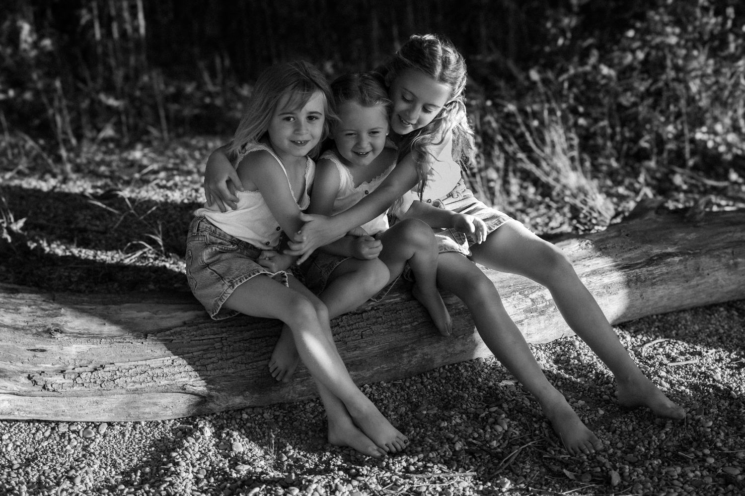 Black and white photo series capturing intimate family moments outdoors.