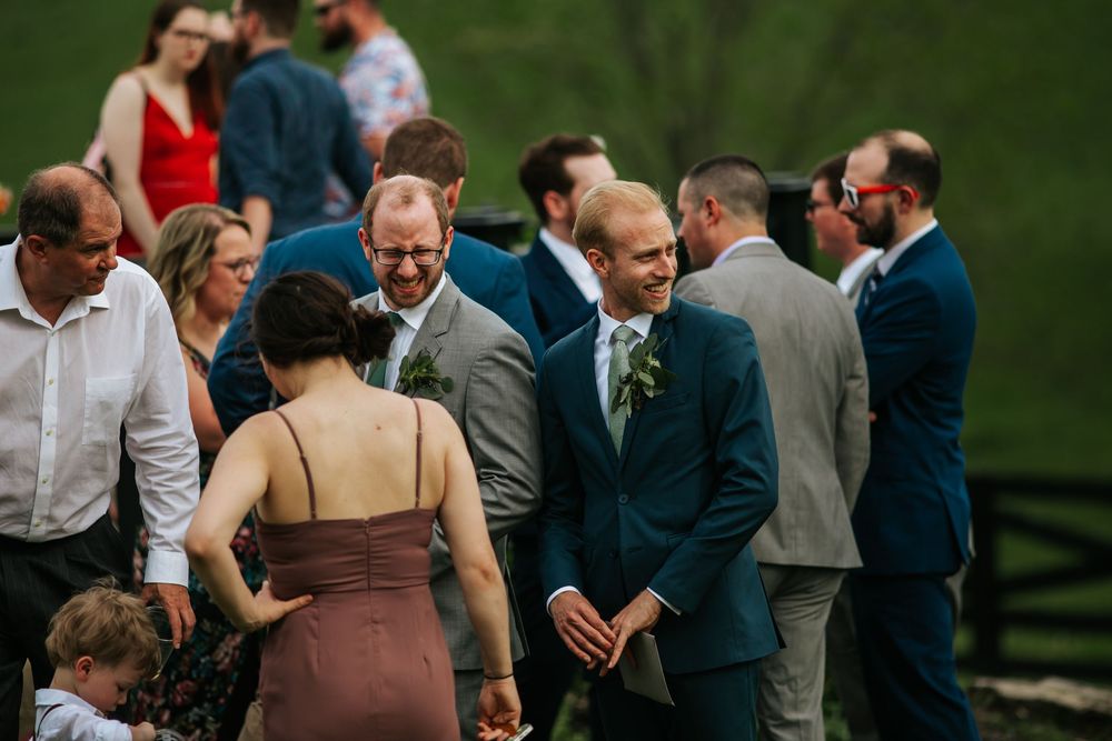 Wedding guests mingling and socializing during an outdoor reception.