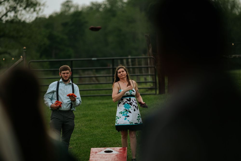 Wedding celebration taking place on a lush green lawn with guests gathering outdoors.