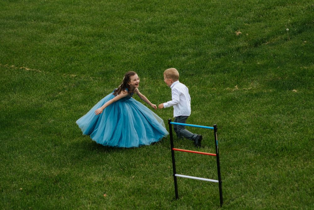 Guests relaxing on colorful lawn chairs during an outdoor wedding celebration.