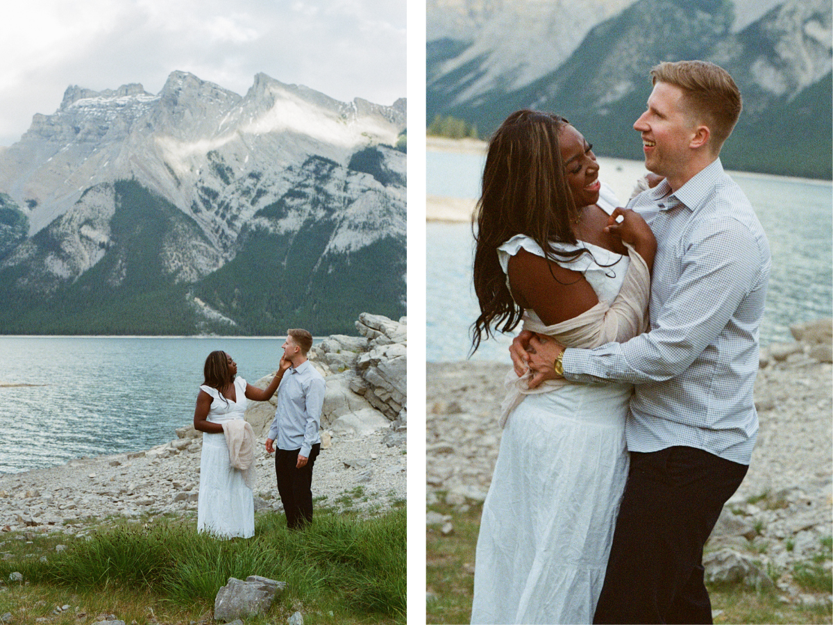 35 mm film photo of bride and groom laughing and holding each other on the shore of a glacier-blue lake in Banff National Park