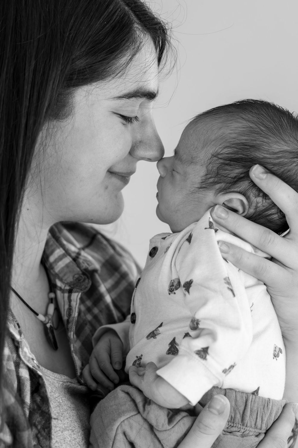 A tender series of black and white photos showing a mother sharing loving moments with her baby.