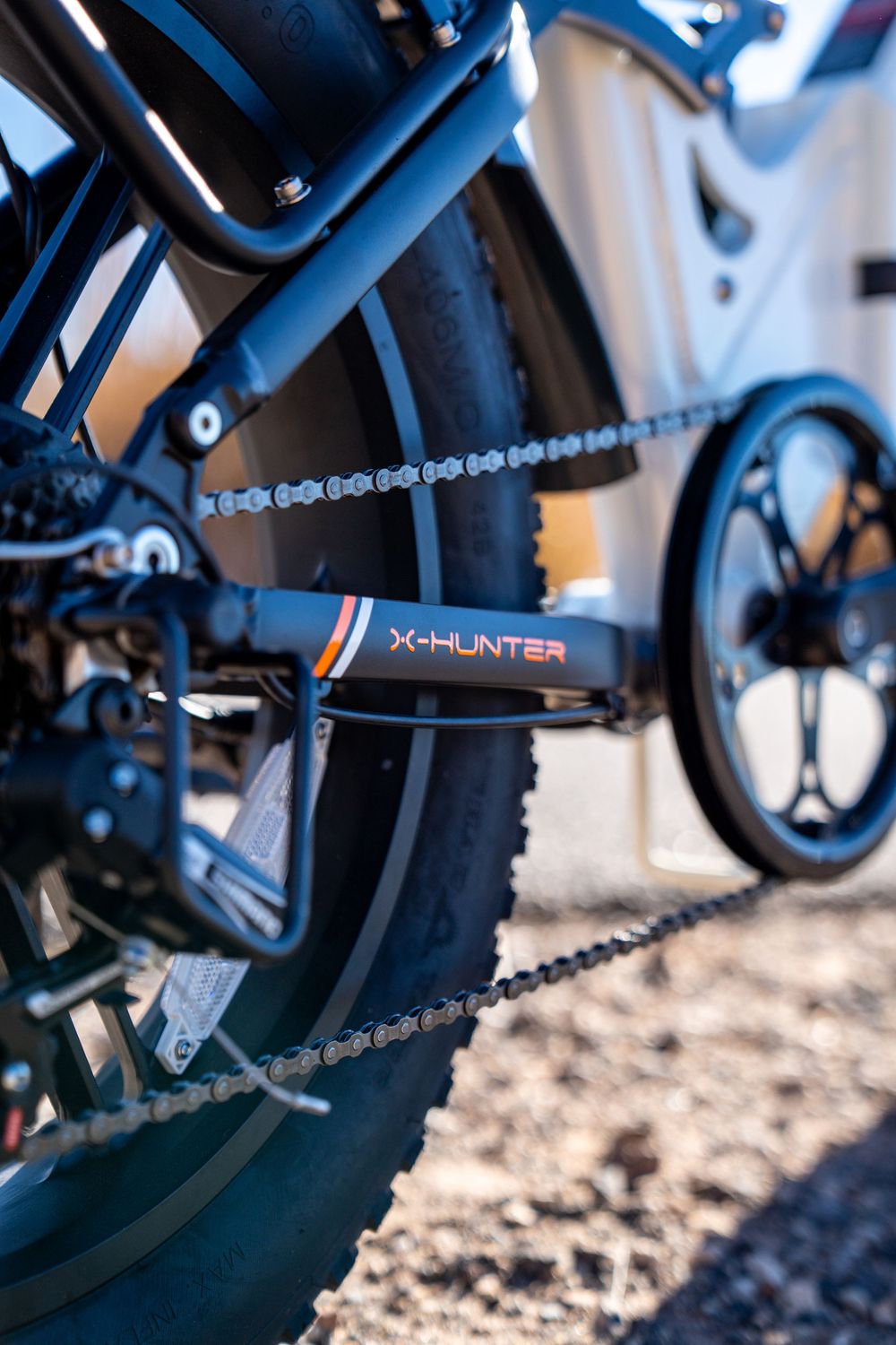 Close-up detail of X-Hunter bicycle chain and gear mechanism.