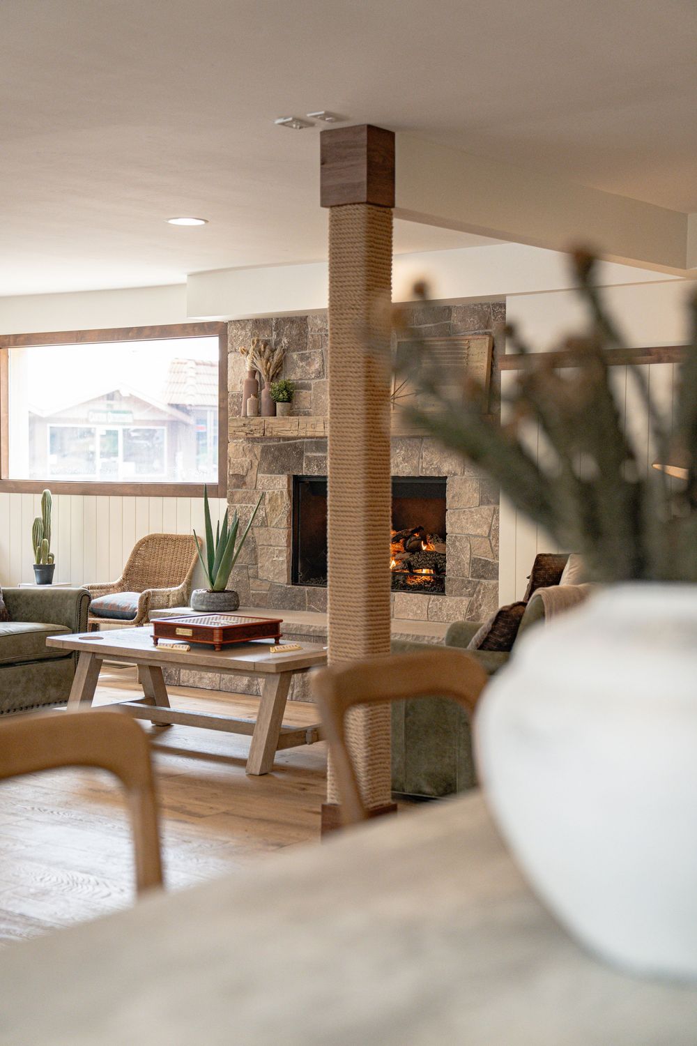 Hotel lobby interior with stone accent walls, comfortable seating, and natural lighting.