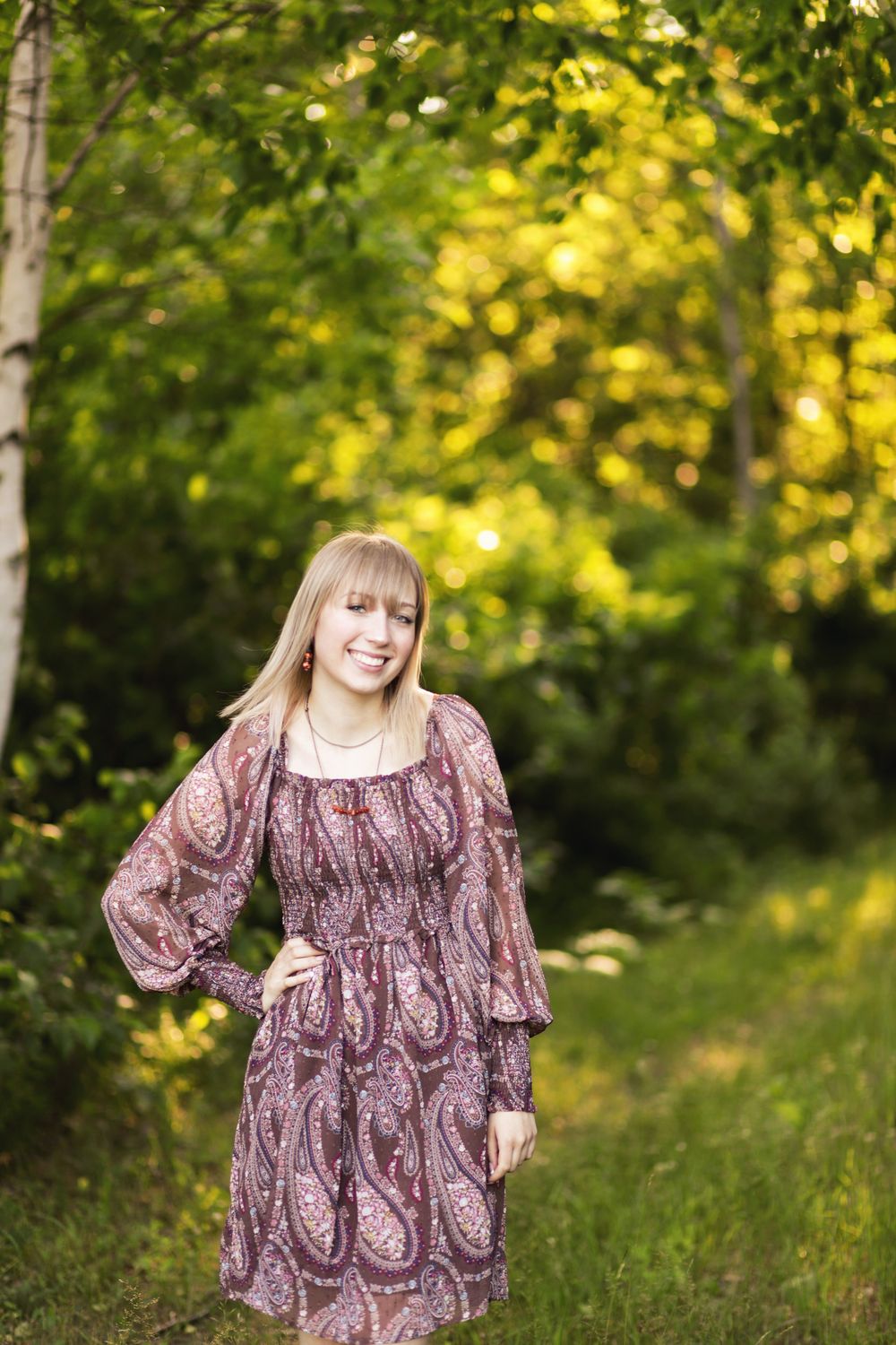 Candid senior photo at a lake cabin during sunset