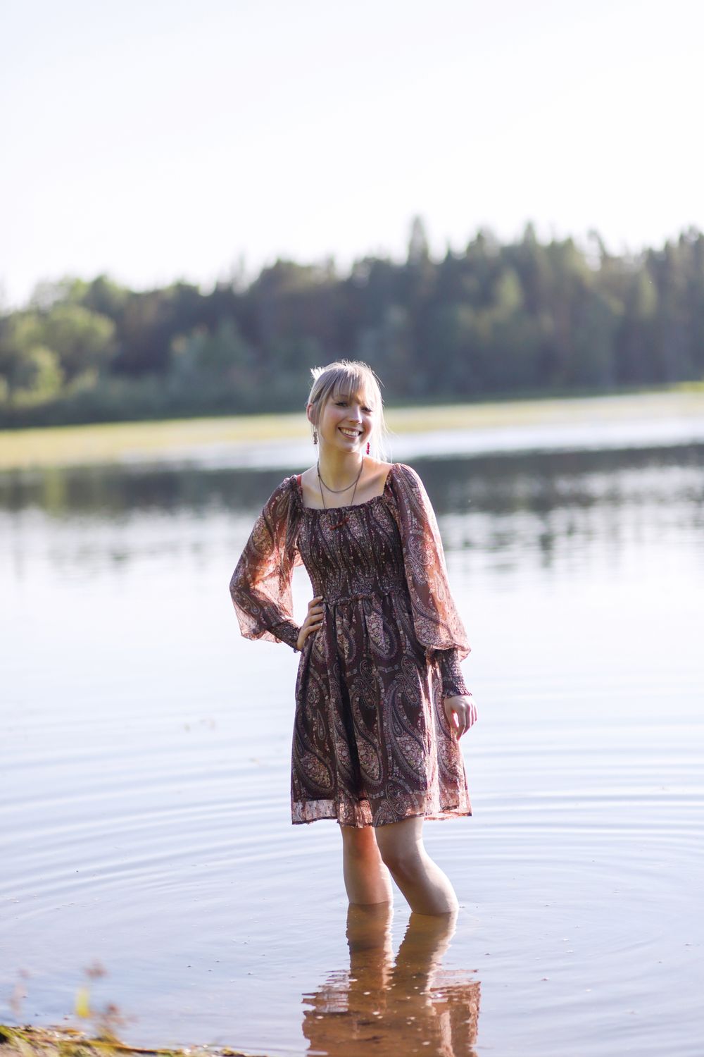 Senior girl walking along the shoreline at Family cabin in Northern WI