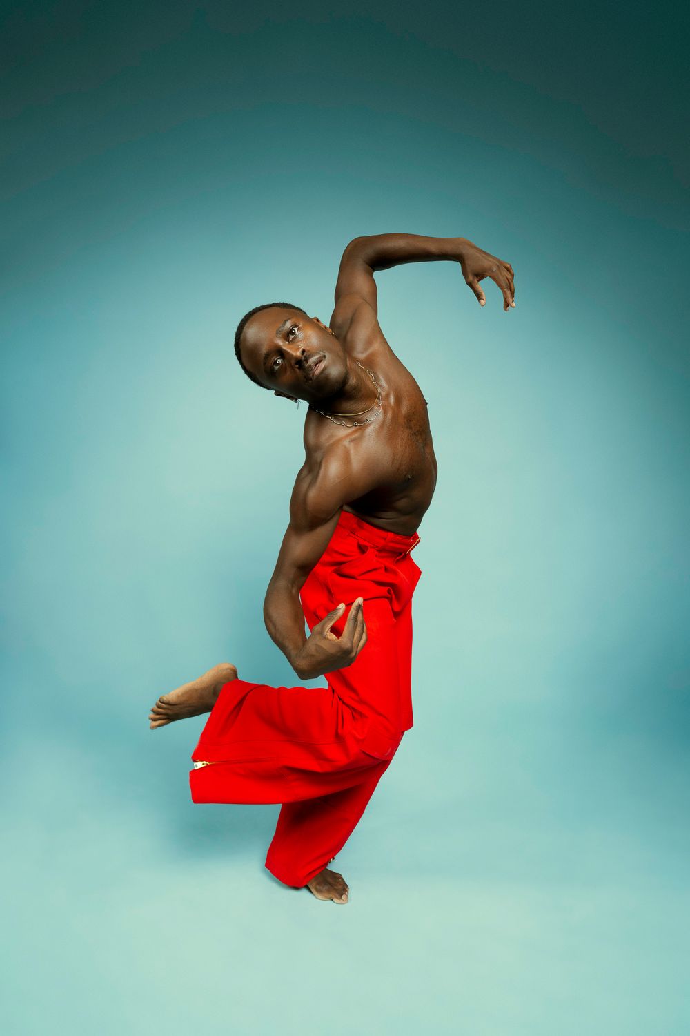 Dynamic dance sequence showing performer in red pants moving expressively against turquoise background.