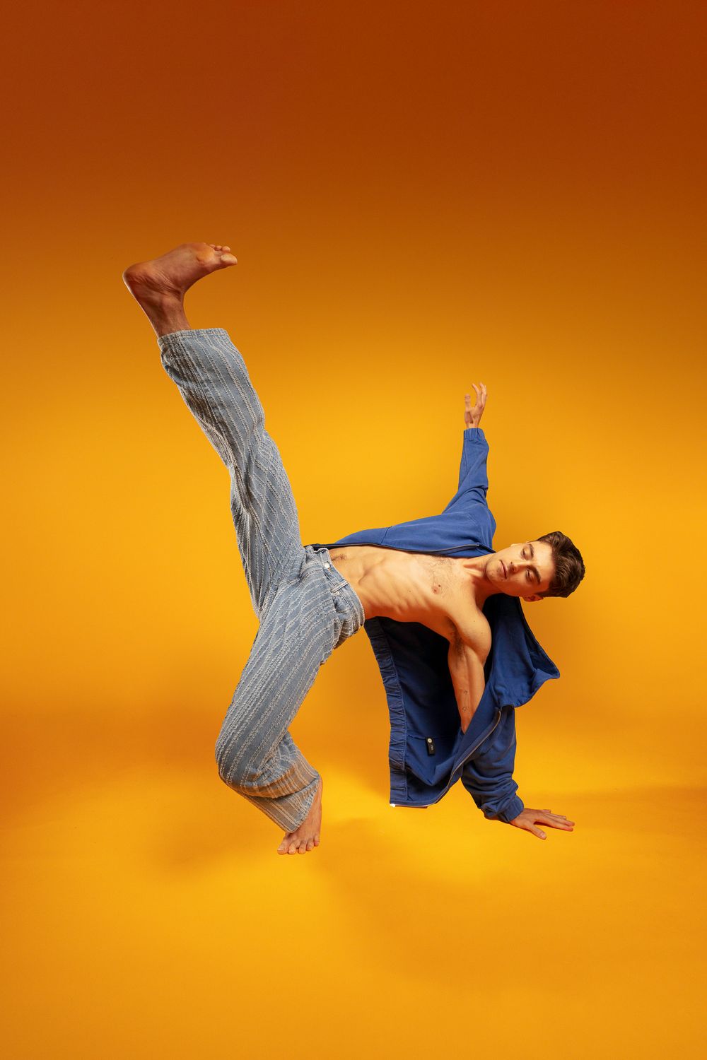 A sequence of dynamic dance moves showing a person in blue top and gray pants performing against an orange background.