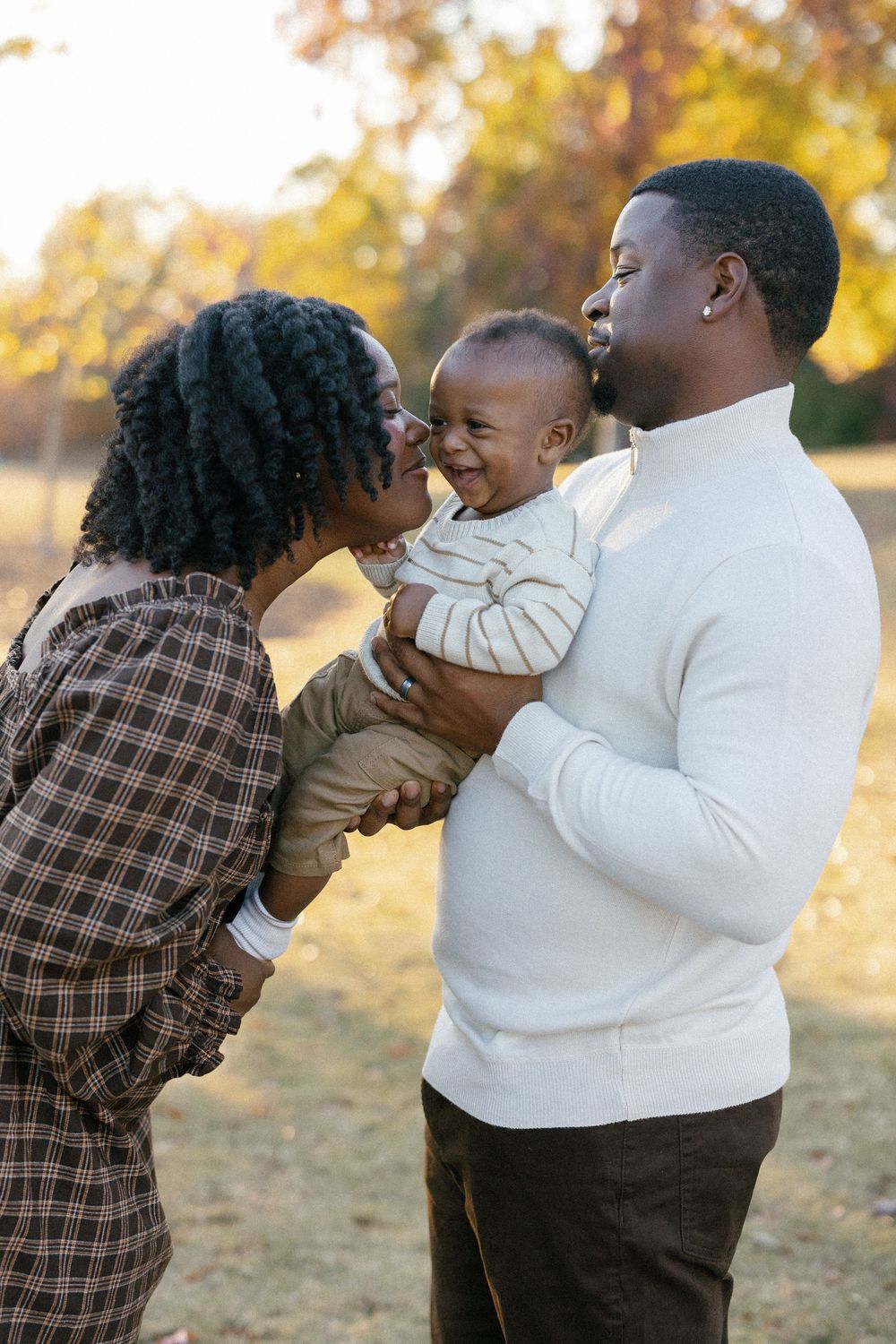 A joyful family moment captured in a series of candid photos during golden hour in an autumn field.