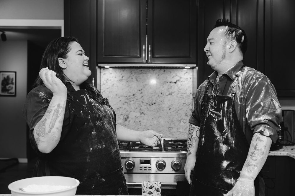 Black and white photo series shows playful moments of two people baking and getting covered in flour.