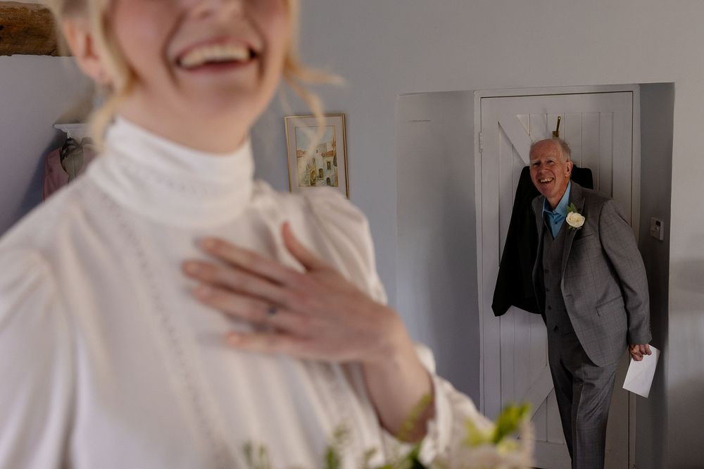 A wedding photo series showing candid moments of joy and laughter between a couple and guests in formal attire.