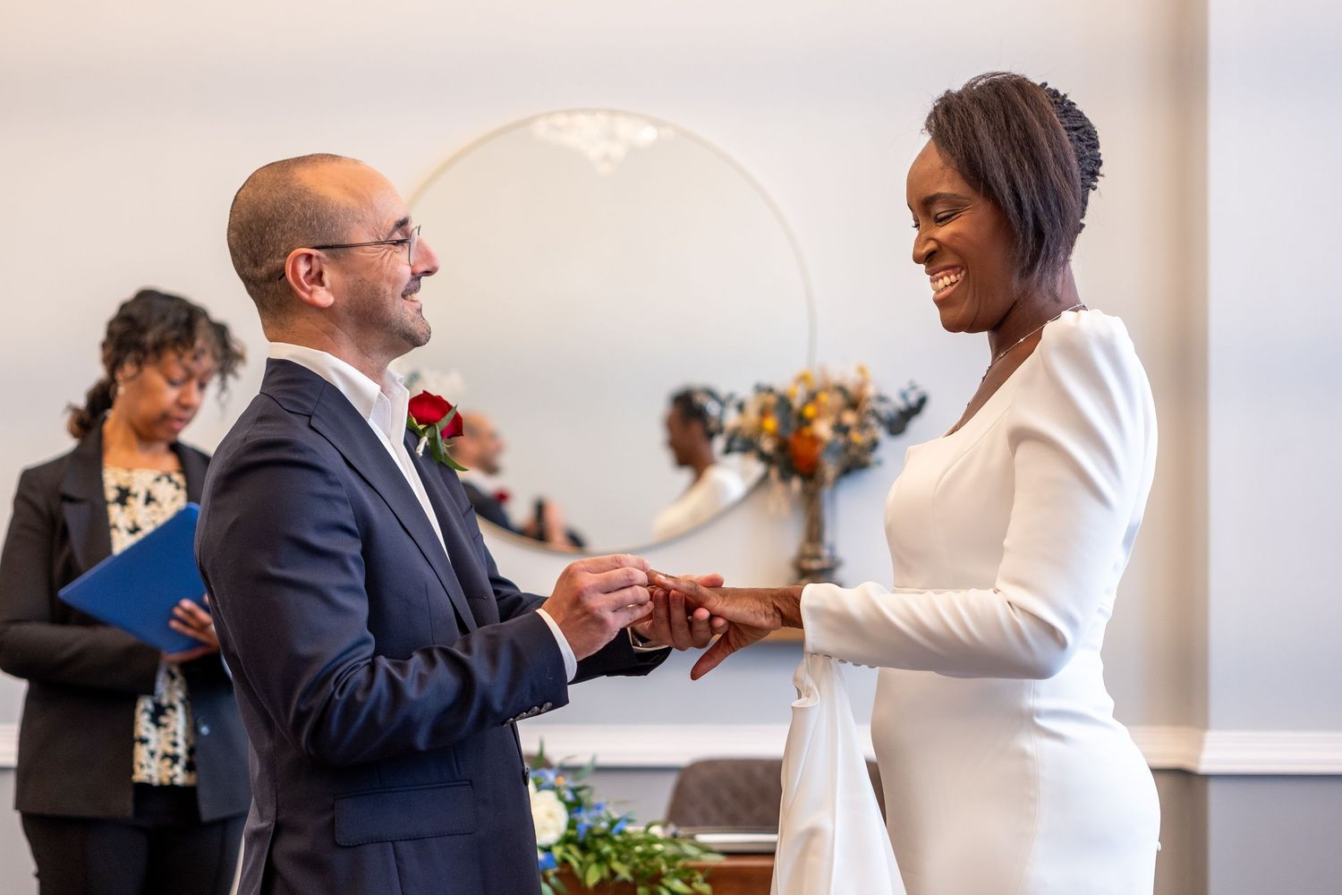 A couple exchanging rings in Islington Town Hall