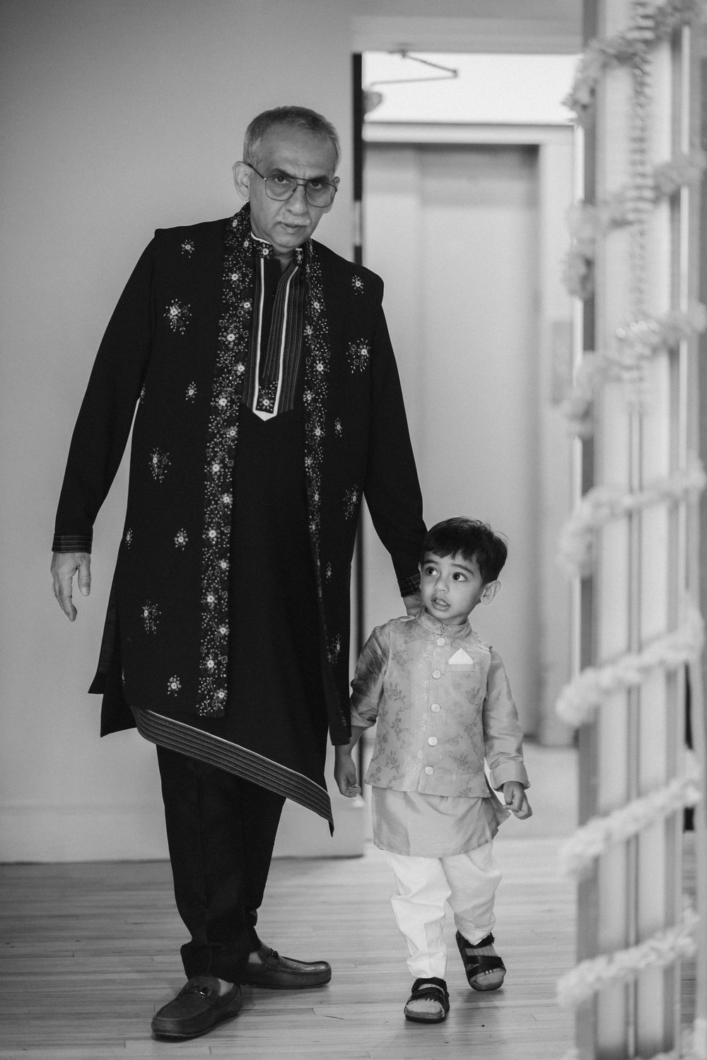Black and white hallway scene with decorative formal attire.