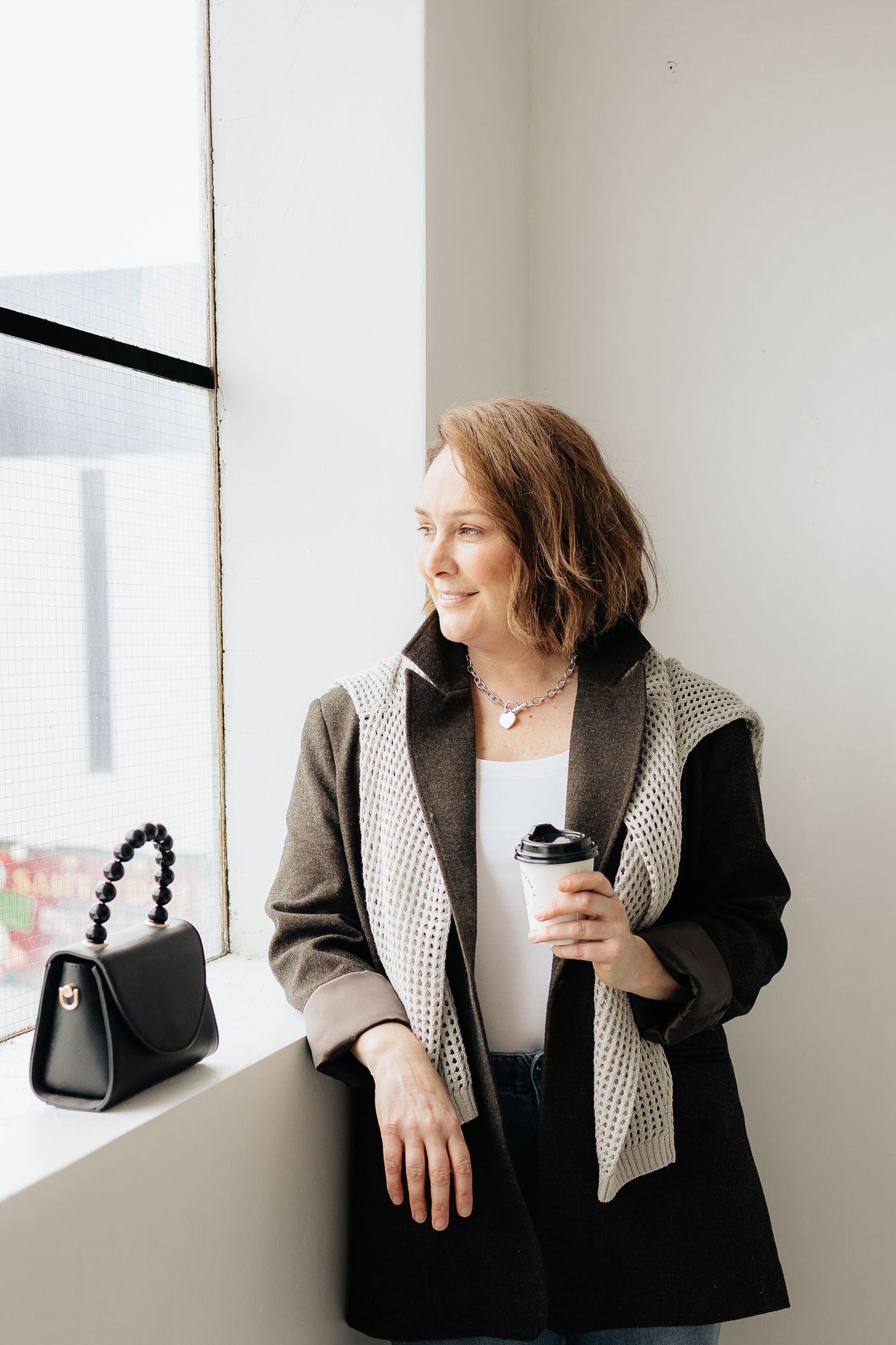 Fashion lifestyle shots showing various poses near a window in modern minimalist setting.