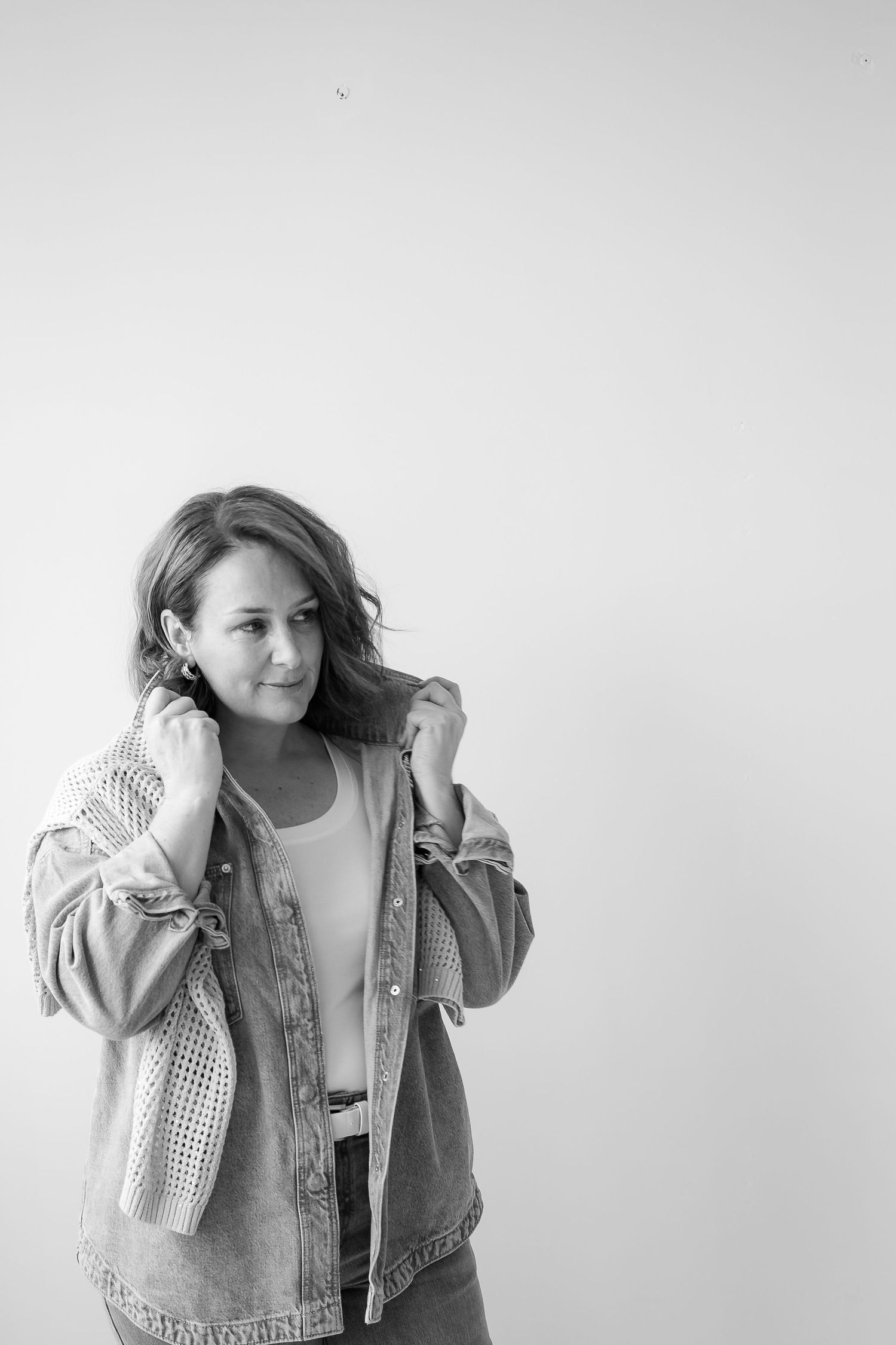 Black and white fashion portraits showcasing layered casual styling with denim and knitwear.