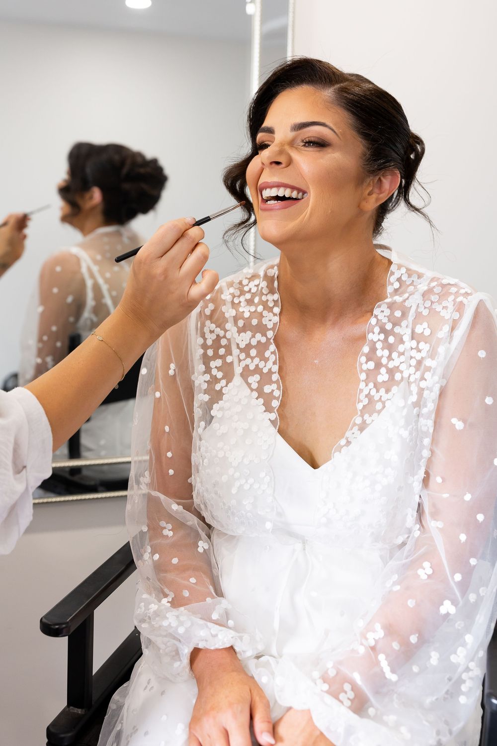 bride getting ready putting on her make up
