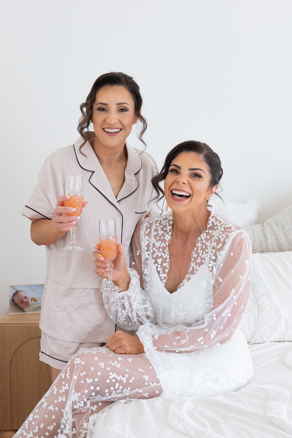 Bride and maid of honour getting ready and enjoying the morning