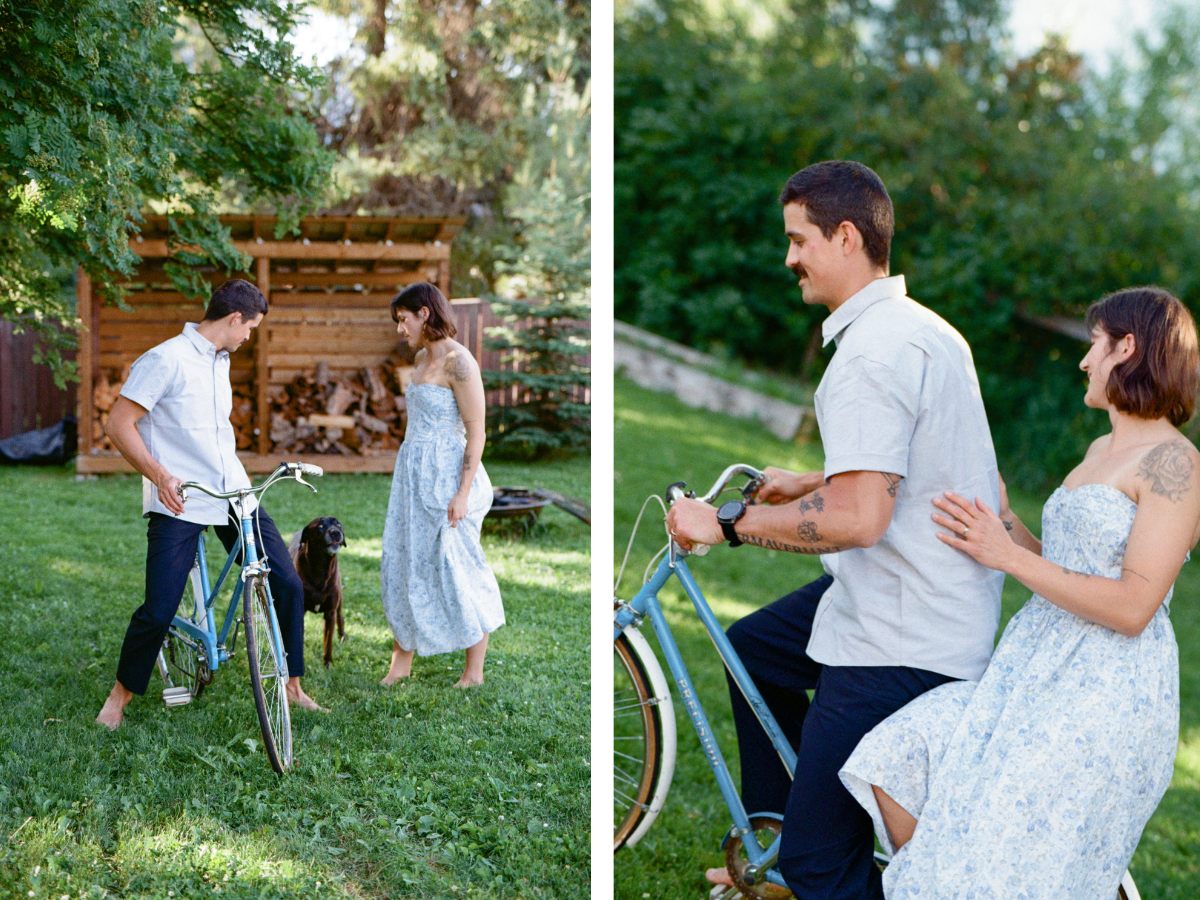 man and woman laugh as they ride a blue vintage bicycle through the grass