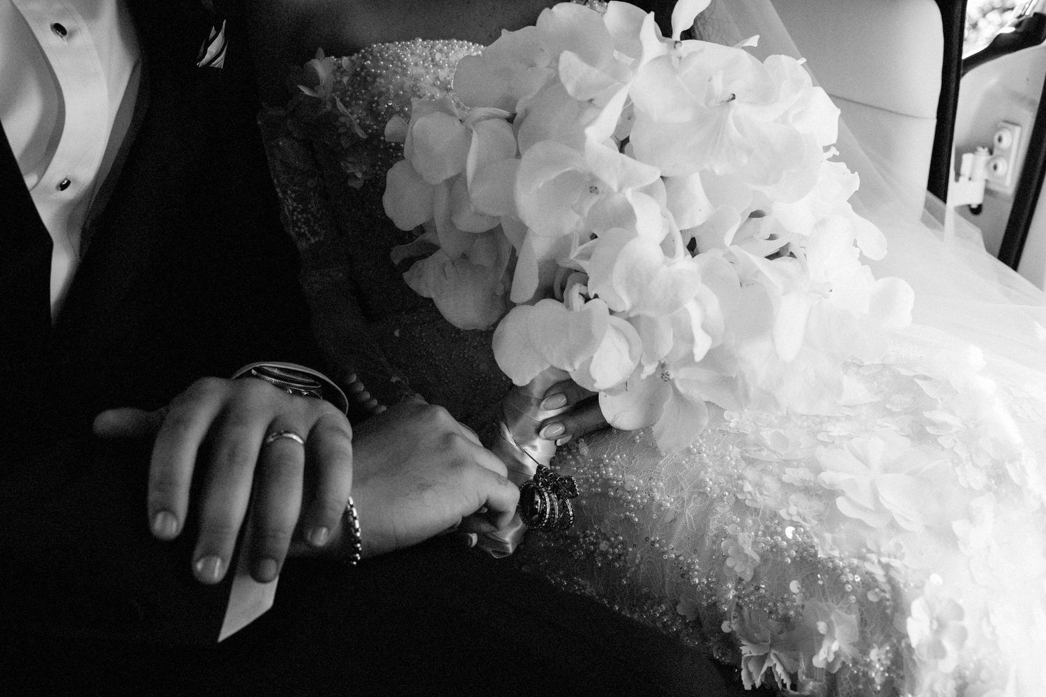 Elegant wedding dress details with delicate white floral embellishments and lace.