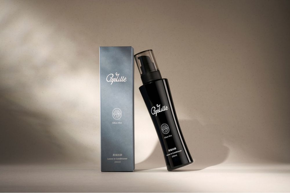 Luxury perfume bottle and packaging photographed in dramatic lighting against a gradient background.