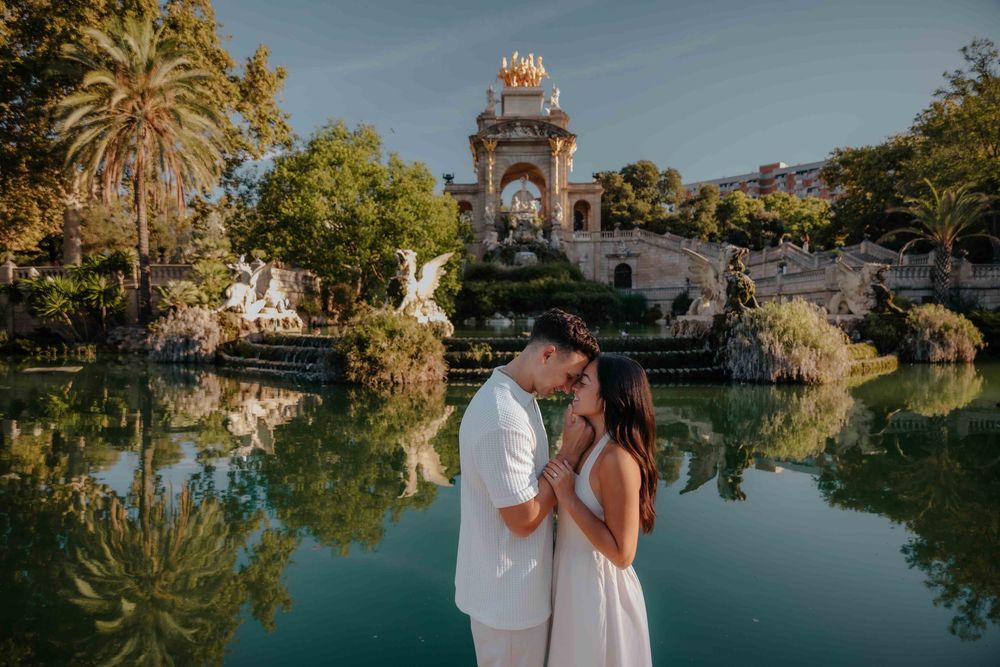 Groom-to-be looking proudly at his fiancée during photoshoot.