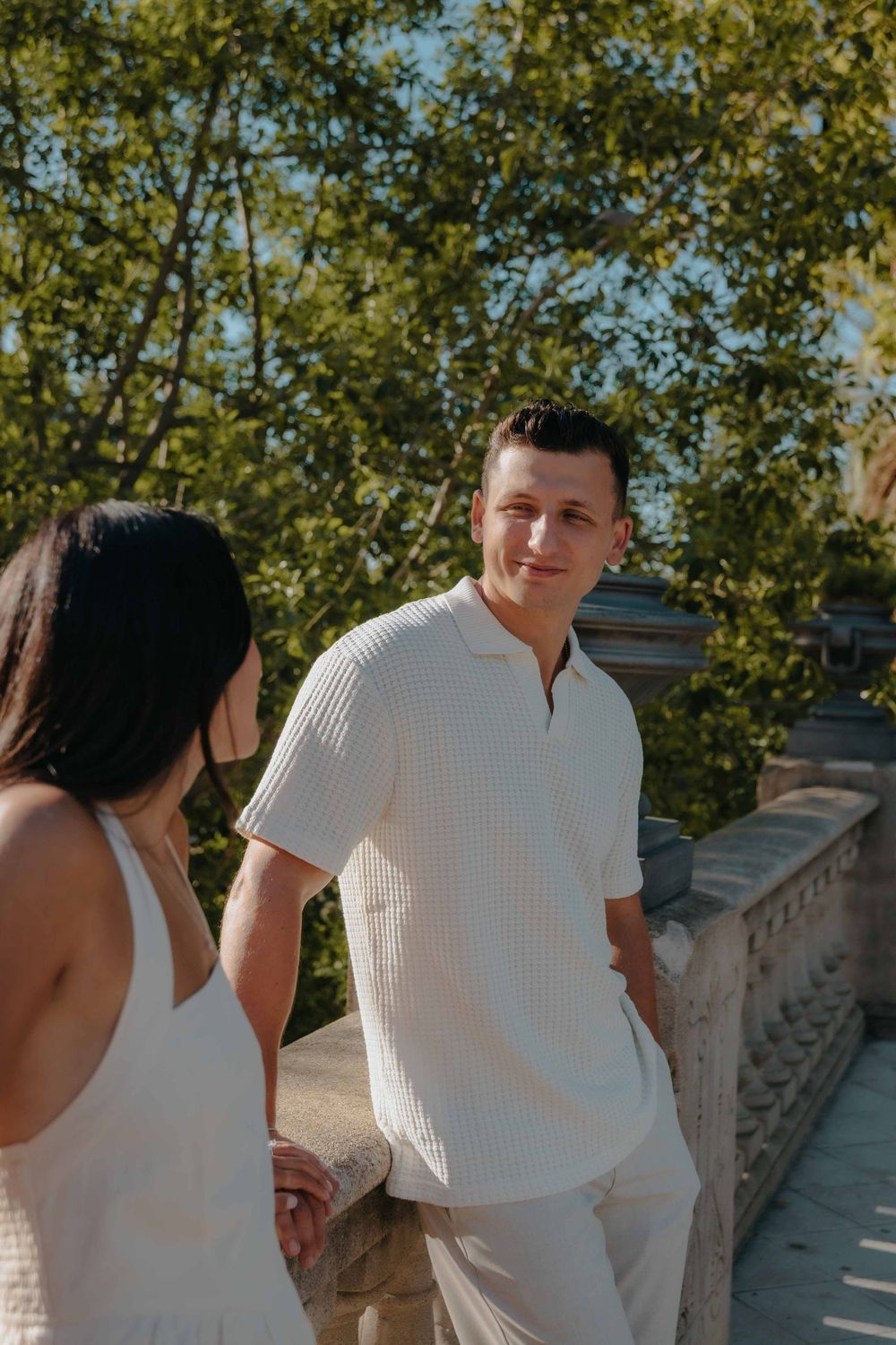 Joyful woman showing off ring while hugging fiancé in Ciutadella Park.