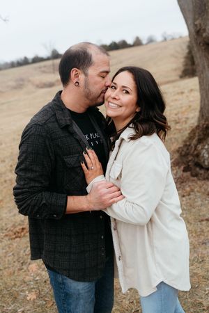 A couple shares romantic moments in a series of candid outdoor photos on a hillside during autumn.