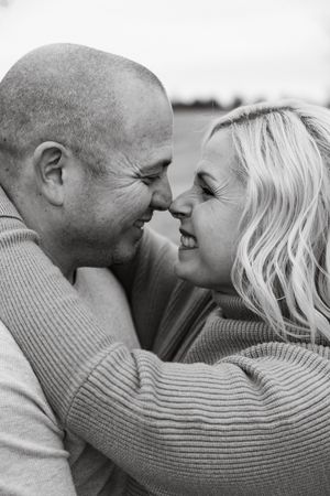 Black and white romantic photo sequence showing a couple in sweaters sharing tender moments together.