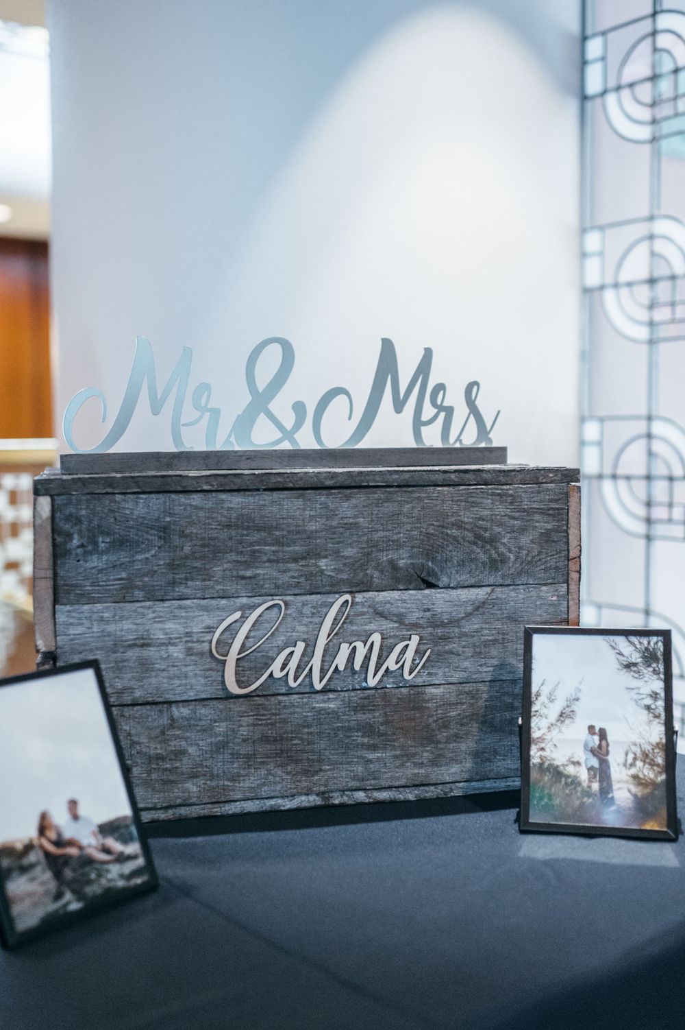 Rustic wooden wedding sign with 'Mr & Mrs' text in elegant calligraphy.