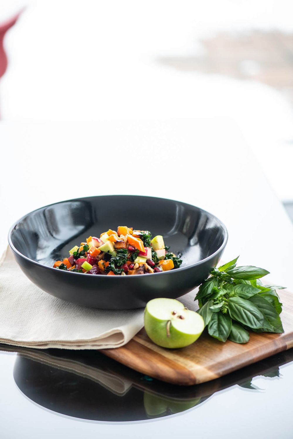 Fresh salad plates with herbs and citrus garnish on wooden serving boards.
