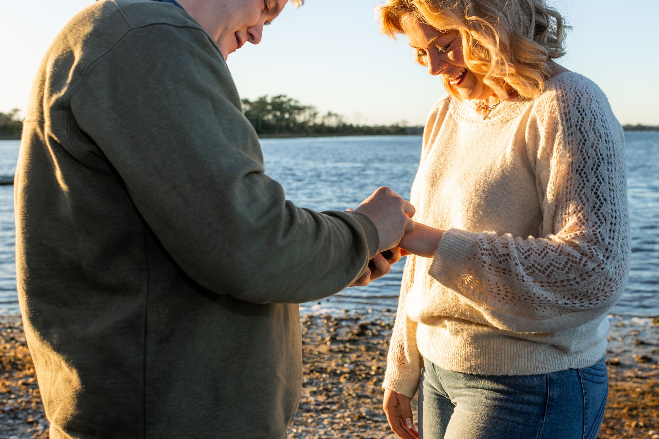 Couple celebrating proposal by the Swansboro waterfront during a Crystal Coast photo session