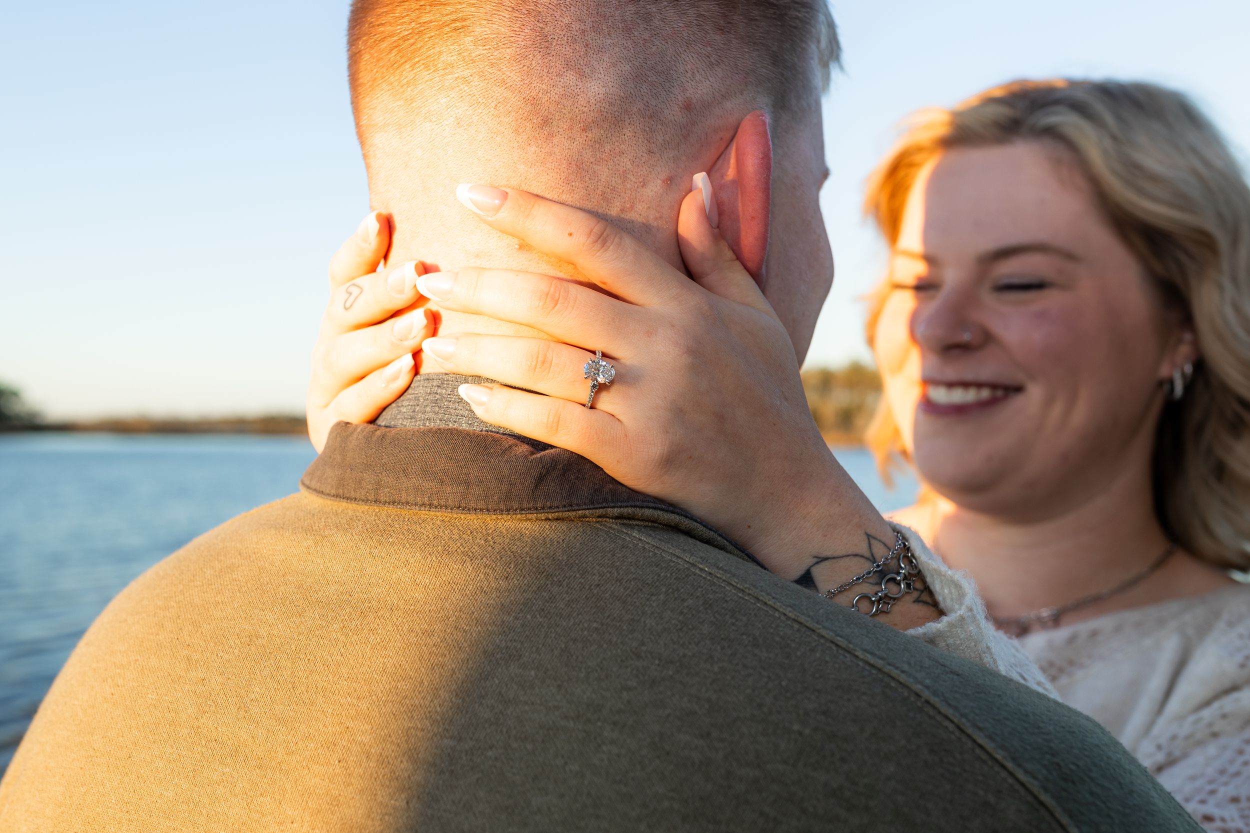 Couple celebrating engagement by the Swansboro waterfront during a Crystal Coast photo session
