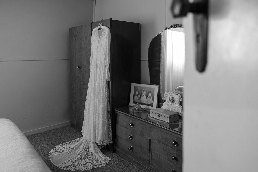 Bride’s wedding dress displayed on a vintage wardrobe in a rural NSW home before an intimate country wedding